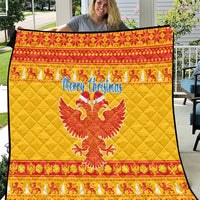 Yellow quilt blanket with red patterned border, “Merry Christmas” and double-headed eagle
