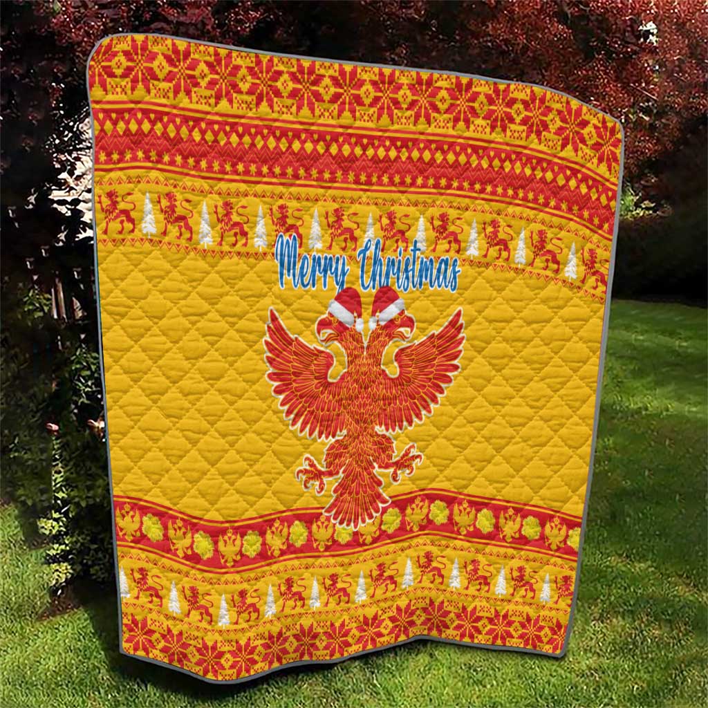 Yellow quilt with red patterned trim, “Merry Christmas” and double-headed eagle design