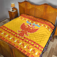 Yellow Christmas quilt on bed with red patterned bands and double-headed eagle centerpiece