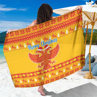 Yellow Christmas sarong with red eagle and holiday border pattern, draped on model