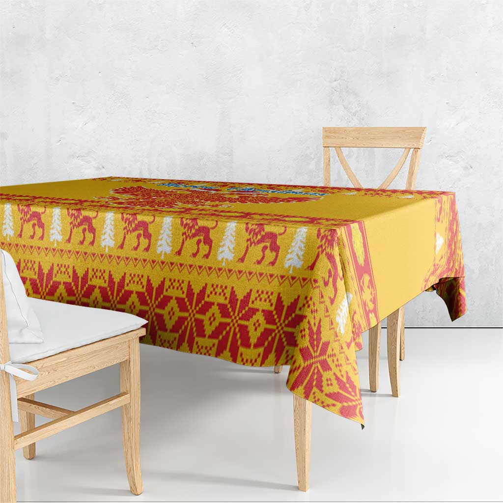 Yellow tablecloth with red and cream animal-and-tree festive pattern, triangular drape