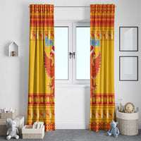 Tall yellow Christmas curtains with double-headed eagle emblem and red patterned top