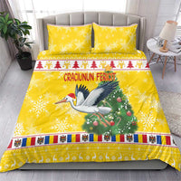 Yellow Christmas bedding set with stork graphic, Christmas tree, and wide striped band