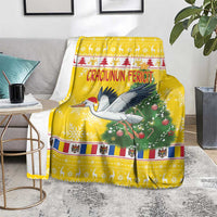 Yellow Christmas blanket spread out with stork and pine tree print