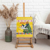 Yellow Christmas canvas wall art featuring a stork, Santa, and Christmas tree