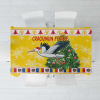 Yellow tablecloth with large stork graphic, Christmas tree, and festive lettering