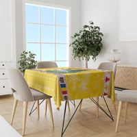 Yellow Christmas tablecloth with stork, Santa, and Christmas tree prints
