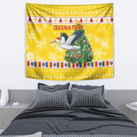 Yellow wall tapestry showing a stork with Santa beside a Christmas tree and holiday borders