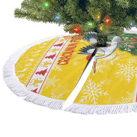 Yellow Christmas tree skirt with stork, snowflakes, and ornaments, with white fringe edge