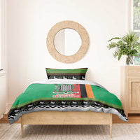 Green Christmas bedding set with central “Zambia Christmas” print, bordered zigzags, and animal band