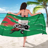 Green personalized sarong showing wolf warrior artwork and red “YOUR TEXT” banner.