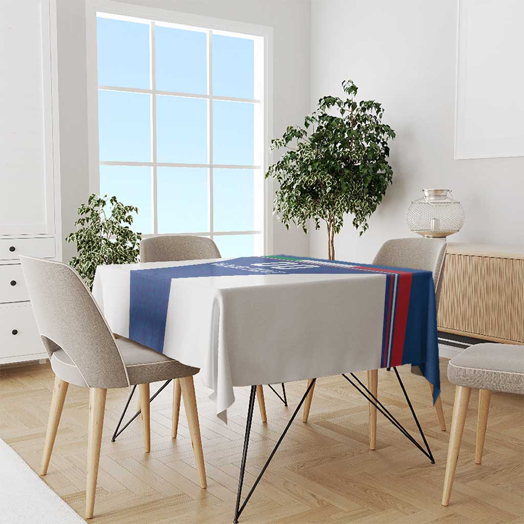 Blue tablecloth with stripe border on dining table with six chairs