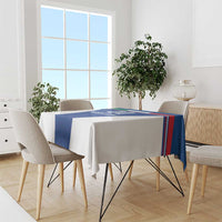 Blue tablecloth with stripe border on dining table with six chairs