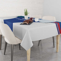 Blue tablecloth with Italy-flag style stripes along edges, draped on dining table