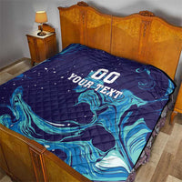 Dark blue quilt on a bed with teal flame waves and large “00 YOUR TEXT” lettering.