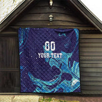 Dark blue quilt displayed on an exterior wall with teal flame waves and “00 YOUR TEXT”.