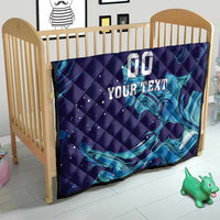 Dark blue quilt in a crib with teal flame waves and custom text “00 YOUR TEXT”.