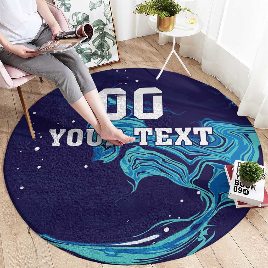 Round custom rug on floor, navy with teal marbled waves and big 'YOUR TEXT'