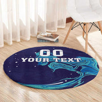 Round custom rug in navy with teal marbled waves and customizable 'YOUR TEXT'