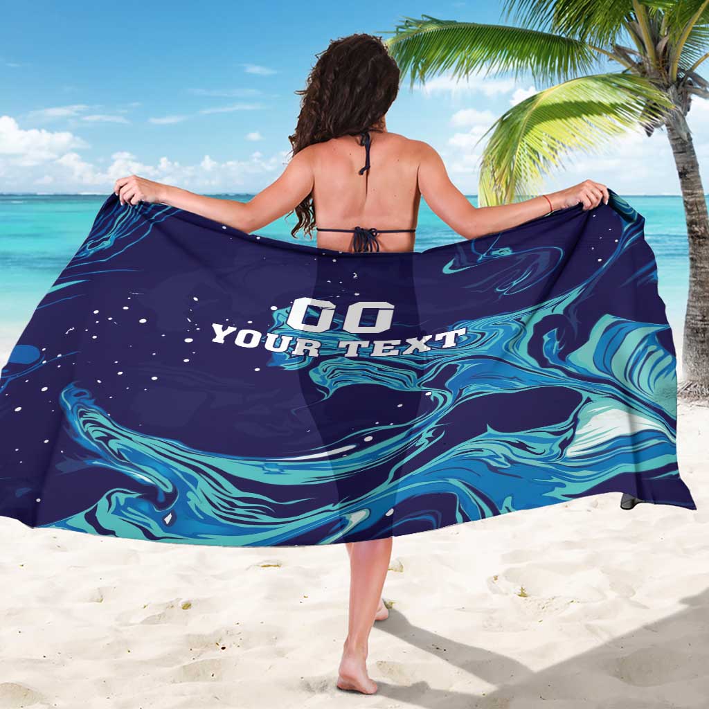 Blue sarong draped over shoulders with aqua wave pattern and custom text design
