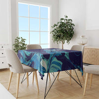 Custom rugby tablecloth in navy blue with teal flame-like swirl pattern, laid on dining table