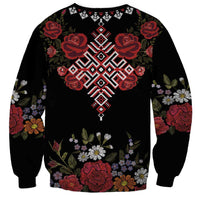 Black unisex sweatshirt with large central red floral motif and decorative sleeves