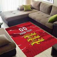 Red area rug with white lettering and yellow lion crest centered