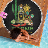 Round black Cinco de Mayo beach blanket with tequila bottle and cactus graphic, white fringe