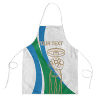 White apron with blue/green vertical stripes, gold emblem, neck loop and waist ties