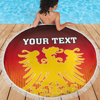 Personalized red round beach blanket (150cm) with white fringe and yellow eagle coat of arms
