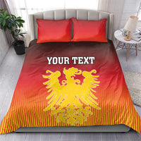 Red duvet and pillow set with yellow coat of arms emblem and “YOUR TEXT”