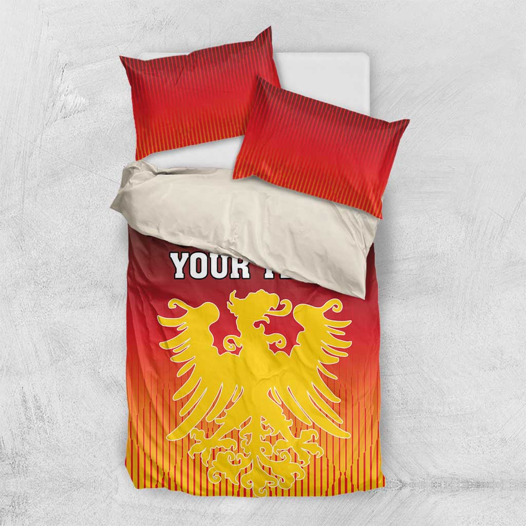 Red bedding set laid flat with “YOUR TEXT” and yellow coat of arms on duvet