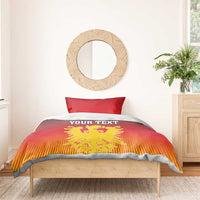 Red bedding set on bed: duvet with “YOUR TEXT” and yellow coat of arms emblem