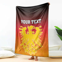Personalized Germany blanket draped on sofa, YOUR TEXT with gold lion crest
