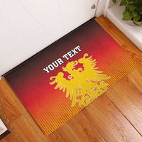 Red-and-orange rubber doormat with coat of arms emblem and 'YOUR TEXT' title