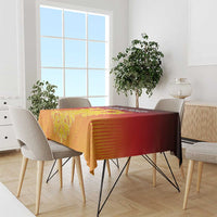 Red and gold striped tablecloth with coat of arms motif on dining table