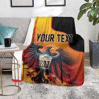 Personalized blanket on floor with “YOUR TEXT,” eagle and Berlin Wall design.