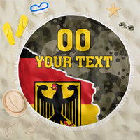 Round beach blanket with fringe edge, green camo and red/yellow German coat-of-arms print