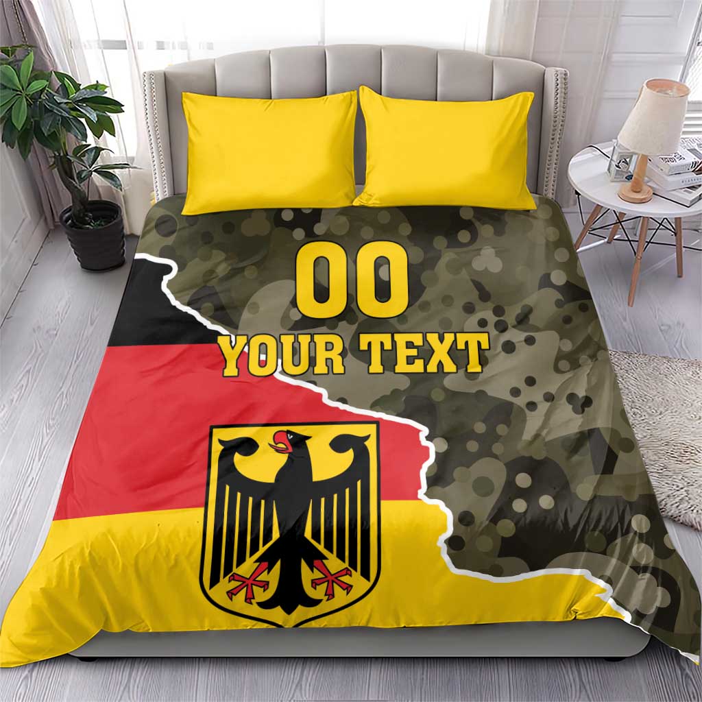 Germany 1990 bedding set showing camo flag print with crest, “00 YOUR TEXT”, and two yellow pillows