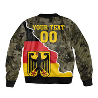 Camouflage bomber jacket with ribbed cuffs; back graphic shows 'YOUR TEXT' and '00'