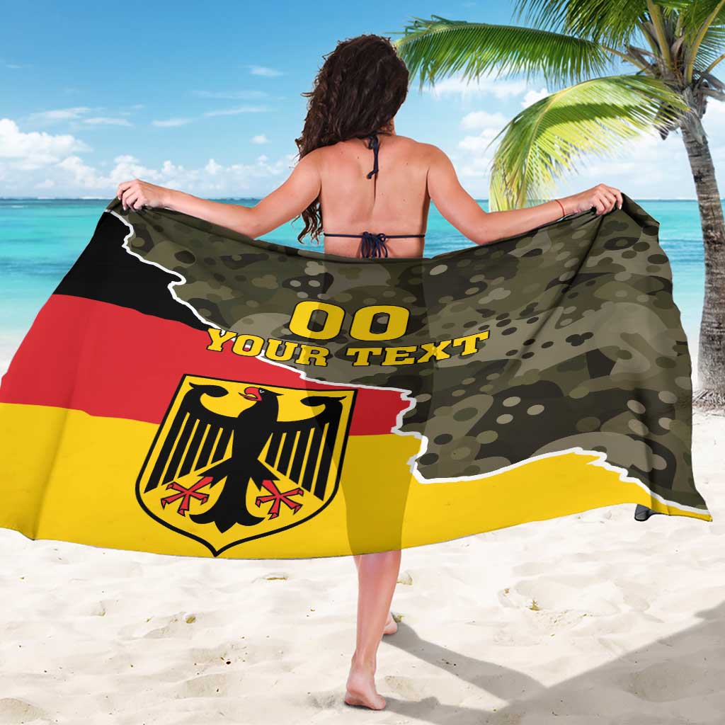 Germany sarong coat with camouflage print, “00 YOUR TEXT” and eagle crest, viewed from back