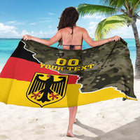 Germany sarong coat with camouflage print, “00 YOUR TEXT” and eagle crest, viewed from back