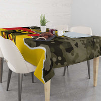 Rectangular camouflage tablecloth with yellow and dark coat-of-arms graphic, draped over table