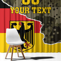 Close view of Germany camo curtain with coat of arms, yellow lettering, and flag colors