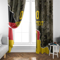Side view of Germany coat of arms camo curtain panels with yellow “TEXT” over window