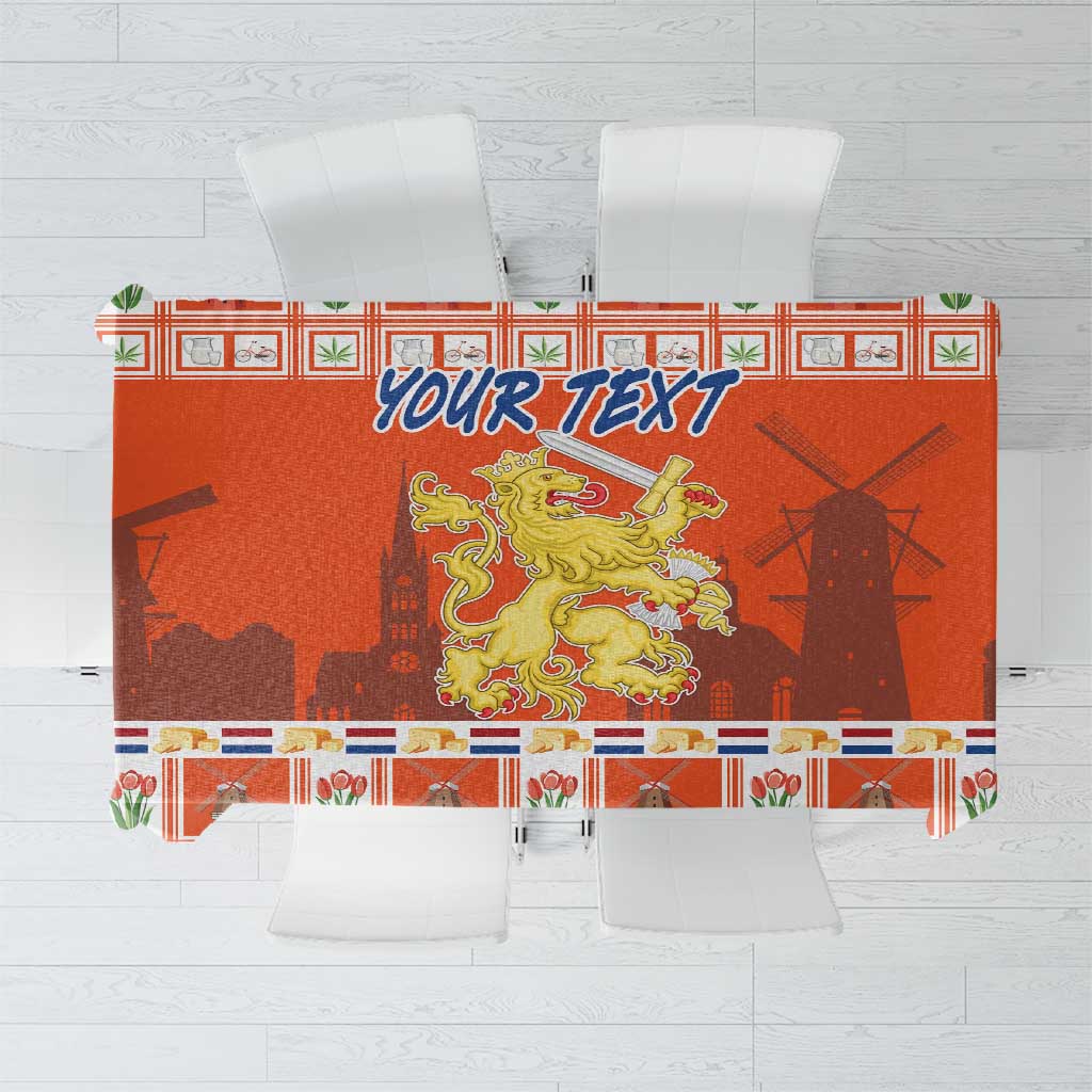 Orange Dutch Christmas tablecloth with coat of arms, patterned border and blue “YOUR TEXT”.