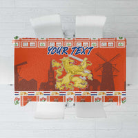 Orange Dutch Christmas tablecloth with coat of arms, patterned border and blue “YOUR TEXT”.