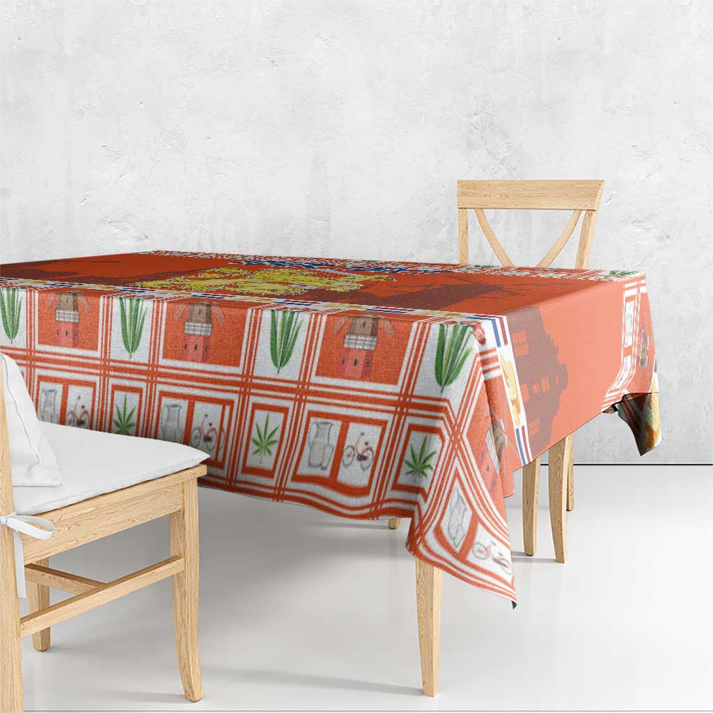 Orange Dutch Christmas tablecloth with coat of arms motif and border print on a table.