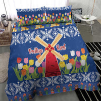 Blue Christmas bedding set featuring tulips, windmill cross, and patterned snow borders