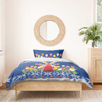 Blue Christmas duvet cover with tulip flowers and windmill motif on a wooden bed